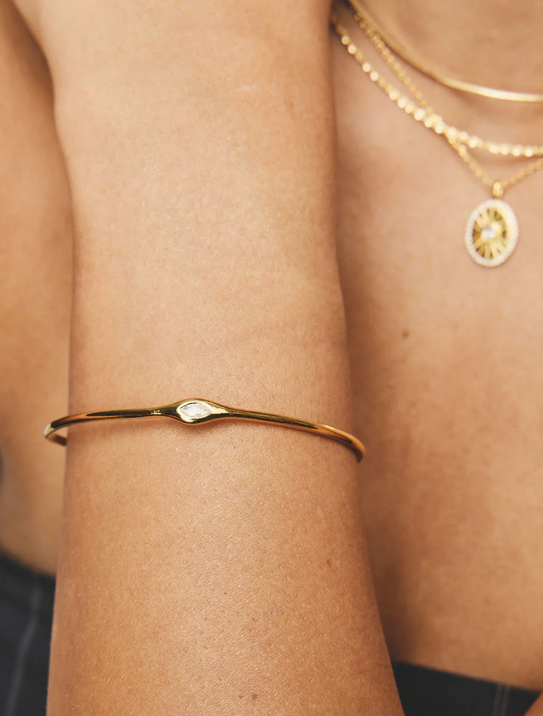 A gold Cheryll Cuff, featuring a modern design that adds a touch of sophistication to any outfit.
