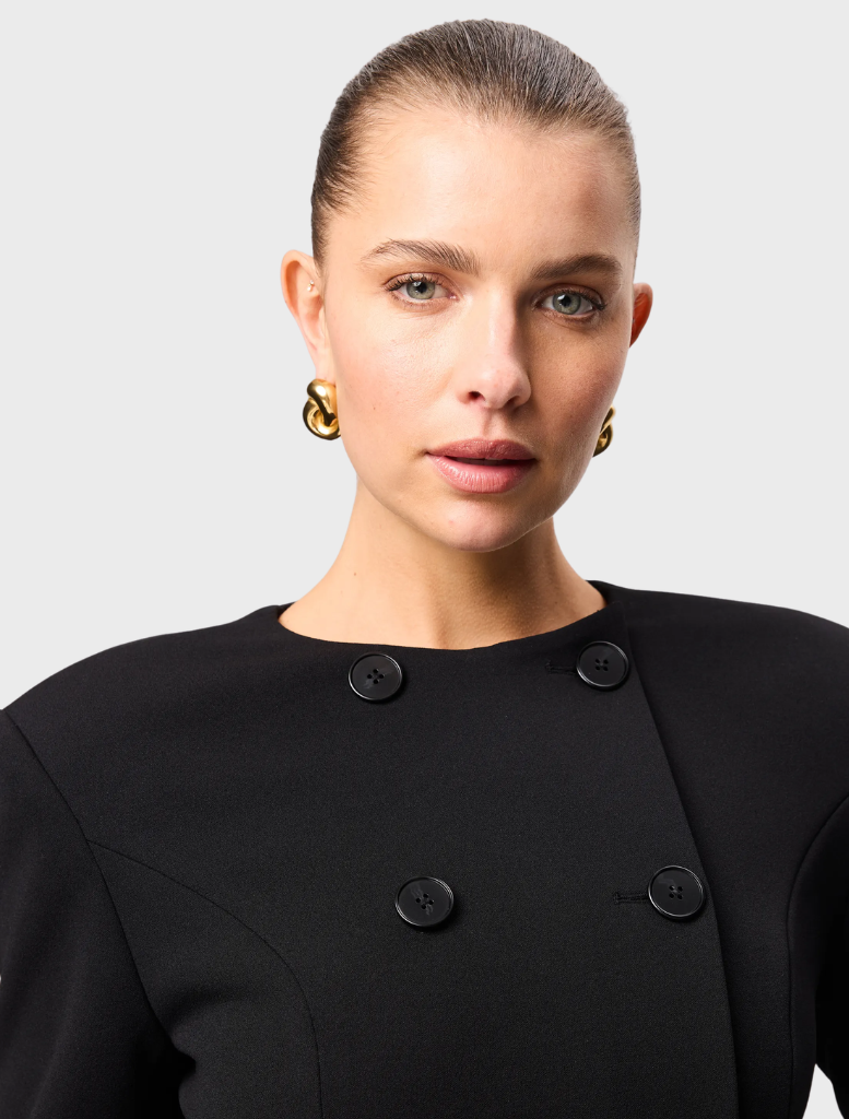 Black mini dress with a fitted silhouette, featuring thin straps and a stylish, modern design suitable for various occasions.