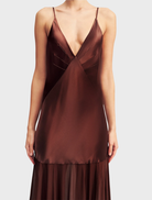 Coffee-colored Moraya Plunged Maxi Dress with a plunging neckline and a graceful, floor-length design for a stylish outfit.