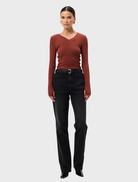 Rust-colored Sedona Top displayed on a mannequin, featuring a relaxed fit and short sleeves.