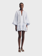 Sky-colored mini dress with balloon sleeves and a playful design, suitable for warm weather and stylish gatherings.