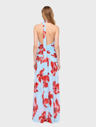 Chic halter maxi dress in blue and pink floral print, designed for comfort and style during summer events.