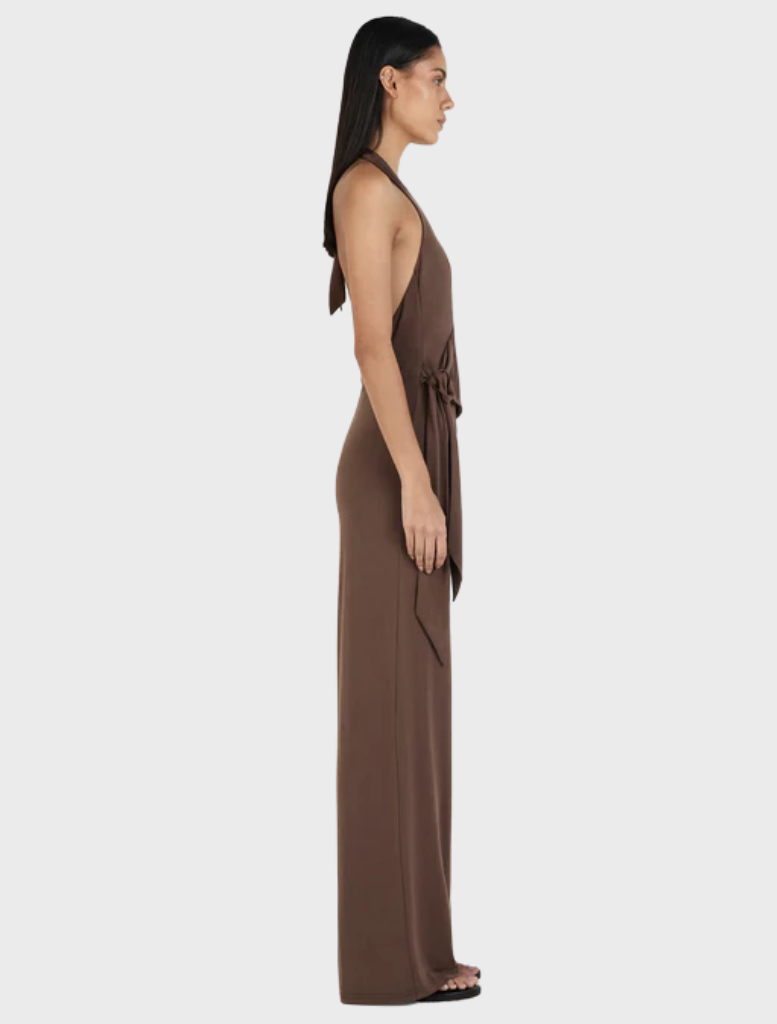 Chocolate Astrid jumpsuit draped on a hanger, illustrating its chic design and versatile appeal.