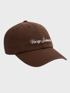 Chocolate brown cap displaying a stylish logo, perfect for casual wear.