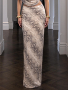 A stylish snake-patterned skirt designed by Christina, showcasing a modern and trendy look for various occasions.