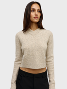 The Claudia V Knit sweater in Urchin, featuring a rich color and intricate knit pattern, displayed on a neutral background.
