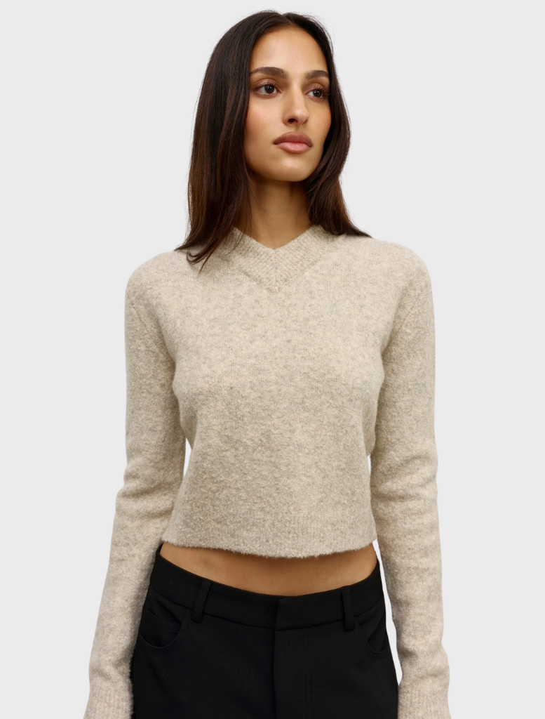 The Claudia V Knit sweater in Urchin, featuring a rich color and intricate knit pattern, displayed on a neutral background.