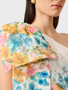 Stylish clementina one-shoulder mini dress with a multi floral print, emphasizing its chic design and vibrant colors.