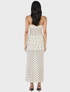 Flowing cream maxi dress with a charming polka dot pattern, ideal for both casual wear and dressier events.