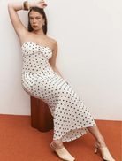 Elegant cream maxi dress adorned with polka dots, showcasing a stylish and comfortable fit for casual or formal events.