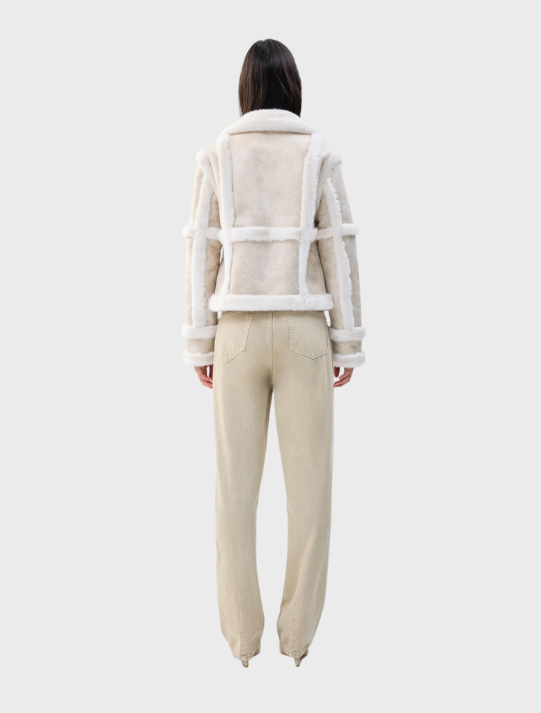 Elegant cream Talamasca jacket showcased, highlighting its versatile style and soft fabric ideal for layering.