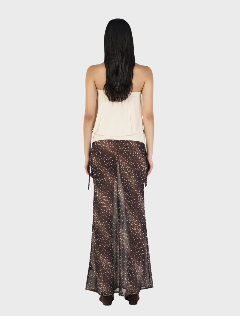 Cream-colored ZOE top displayed on a hanger, featuring a simple design and soft fabric texture.