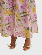 Model wearing a lilac floral sundress with a halter neckline, showcasing a lightweight, sleeveless, midi-length design.