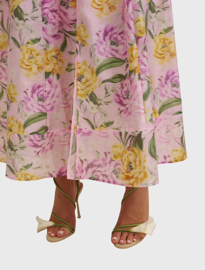 Model wearing a lilac floral sundress with a halter neckline, showcasing a lightweight, sleeveless, midi-length design.