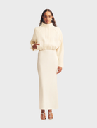 Ivory cropped bomber jacket with a stylish design, featuring a front zipper and ribbed cuffs.