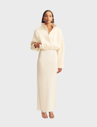 Ivory cropped bomber jacket with a stylish design, featuring a front zipper and ribbed cuffs.