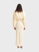 Stylish ivory cropped bomber jacket featuring a zip front and ribbed cuffs, ideal for a trendy outfit.
