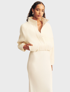 Elegant ivory bomber jacket, cropped length, showcasing a modern silhouette and ribbed detailing.