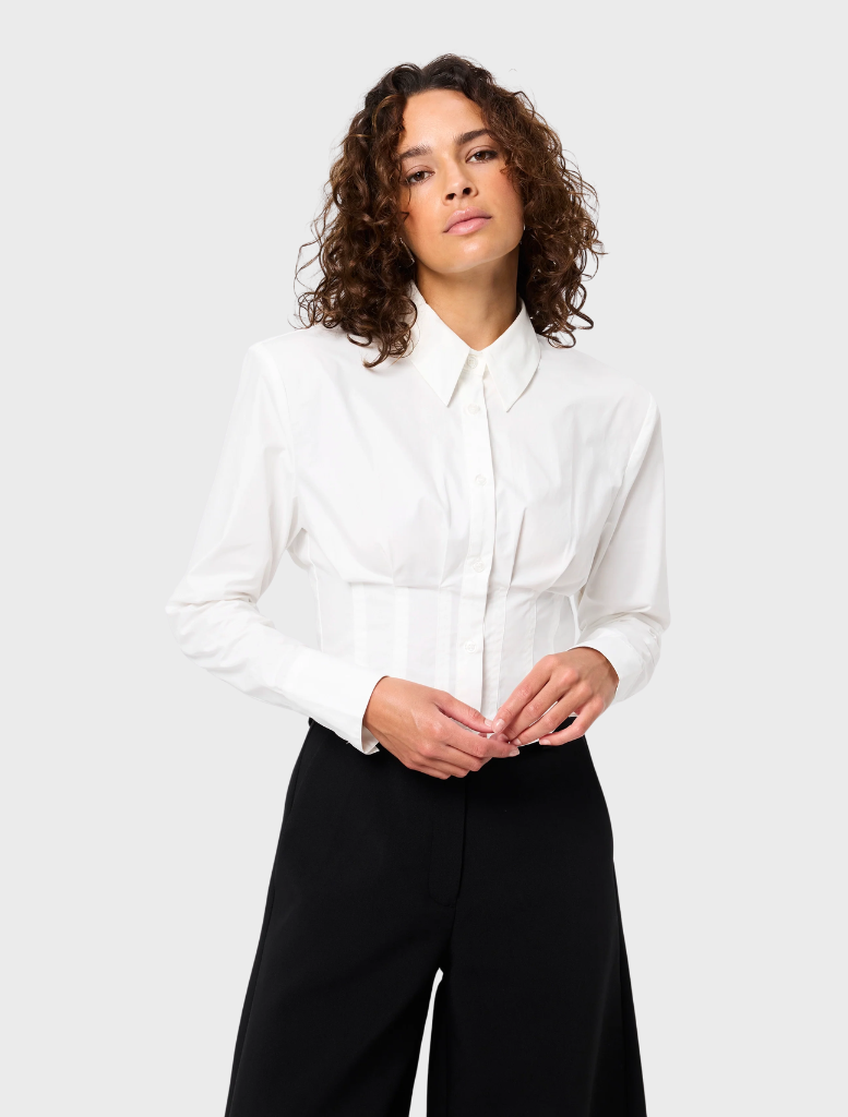 White Darcy shirt displayed on a hanger, featuring a classic collar and button-down front.
