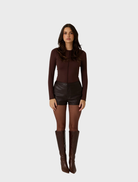 Dark truffle shorts made from vegan leather, combining elegance and sustainability in a chic design.