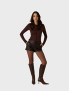 Dark truffle shorts made from vegan leather, combining elegance and sustainability in a chic design.