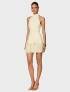 A delightful mini lemon, vibrant yellow in color, showcasing a glossy finish that adds a touch of whimsy.