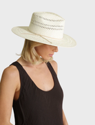 White Debra Fedora hat displayed on a neutral surface, illustrating its refined design and fashionable appeal.
