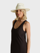  White Debra Fedora hat displayed against a neutral background, showcasing its elegant design and classic style.