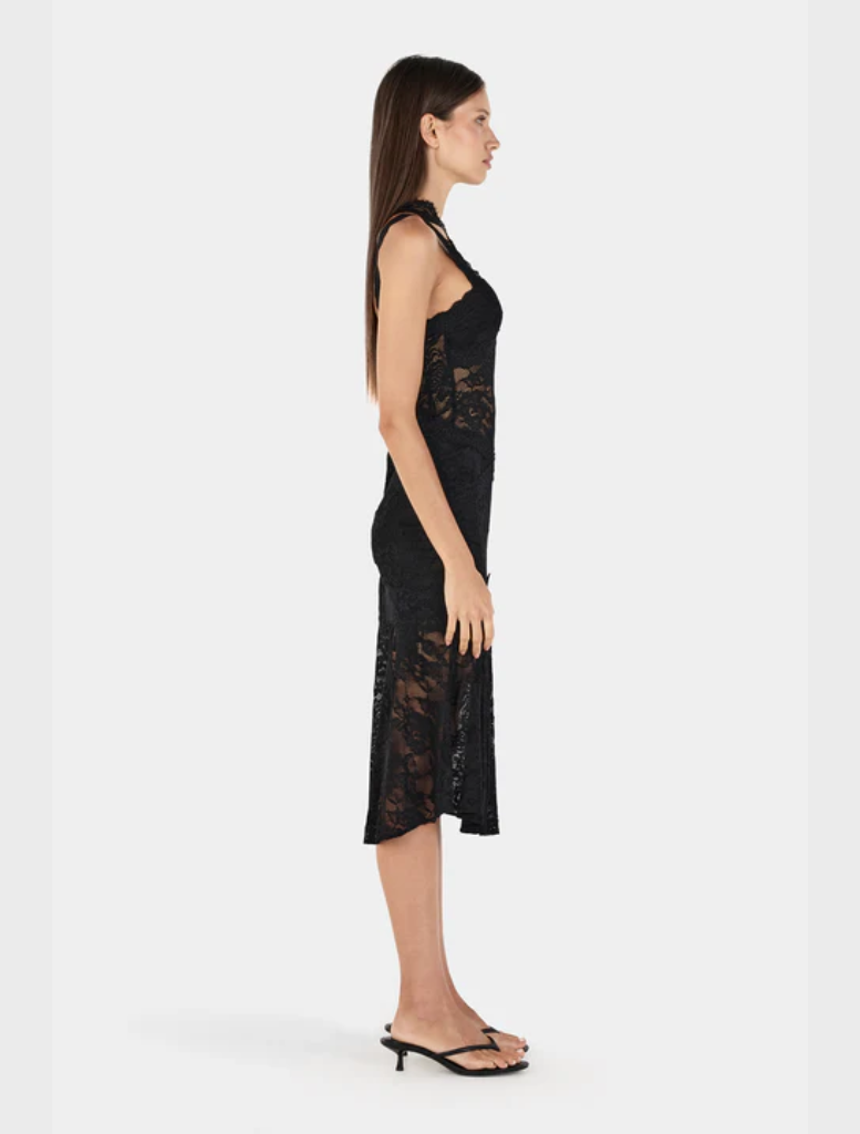 Chic black Della dress, highlighting a form-fitting style and a beautifully draped skirt for elegant wear.