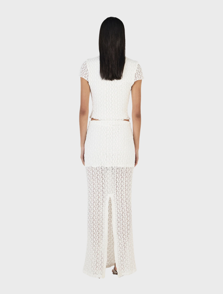 Ivory Delphine skirt laid flat, showcasing its smooth texture and graceful cut, perfect for formal or casual wear.