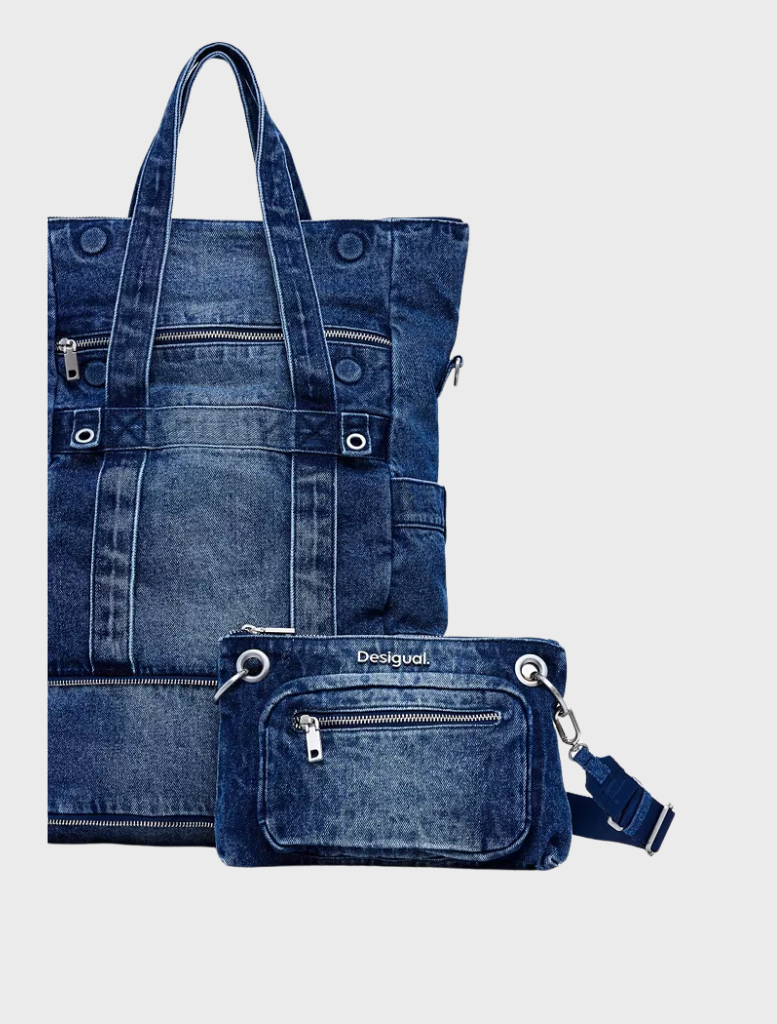 Stylish blue denim mini backpack with a zipper closure, perfect for carrying essentials while maintaining a trendy look.