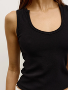 Front view of a black Devon tank top, emphasizing its minimalist design suitable for various outfits.