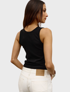 Black Devon tank top presented on a neutral backdrop, illustrating its elegant simplicity and everyday comfort.