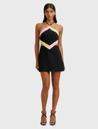 Black, pink, and orange Diamond Halter Mini Dress with a fitted silhouette, lace-up back, and subtle waist cut-outs.