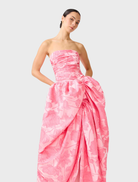 Pink strapless ball gown with a fitted bodice and flowing skirt, perfect for formal occasions.
