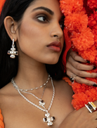 Elegant silver Diya necklace showcasing detailed artistry and style.
