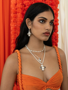 Silver Diya necklace featuring intricate design and elegant craftsmanship, suitable for formal and festive occasions.