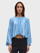 Lapis Dreamt Blouse features soft gathering at the neckline, wide sleeves, and a relaxed, billowing silhouette for elegance.
