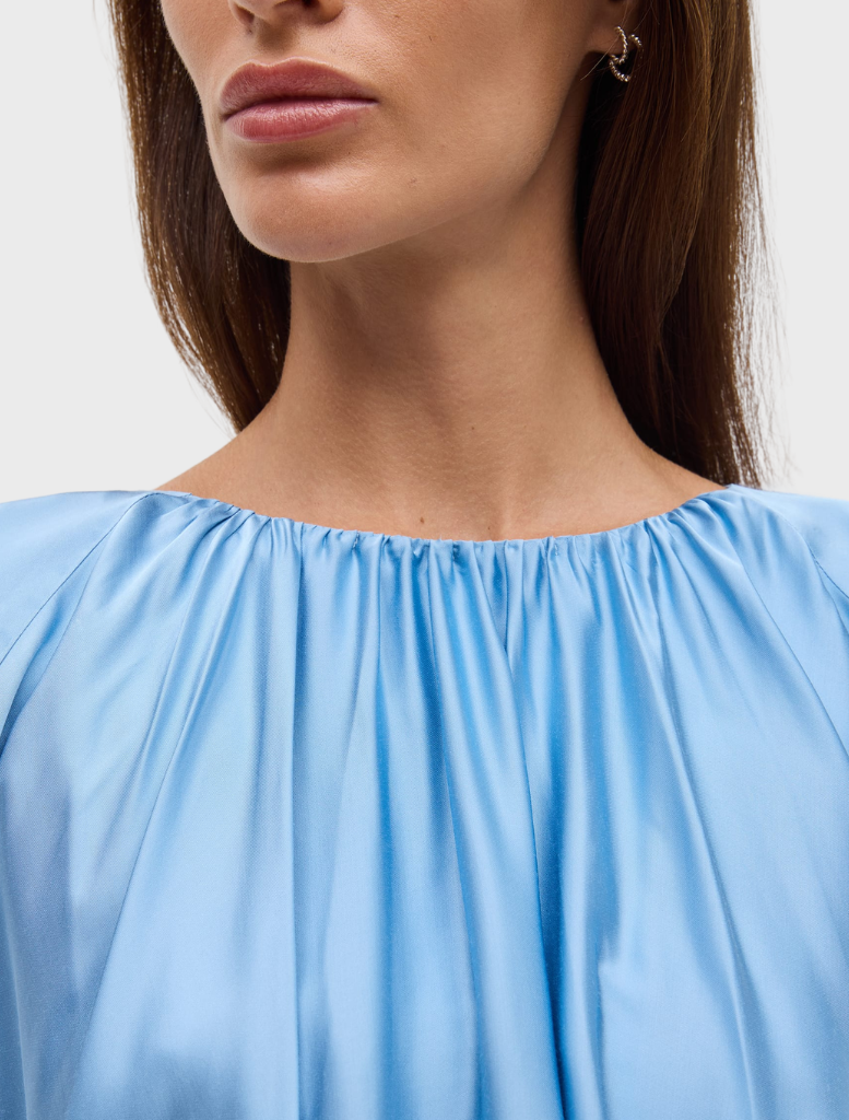 Lapis Dreamt Blouse offers a relaxed fit with gathered neckline, wide sleeves, and a flowing silhouette for an elegant look.