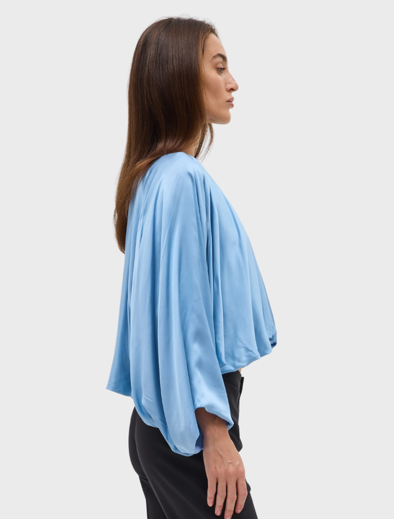 Lapis Dreamt Blouse features soft gathering at the neckline, wide sleeves, and a relaxed, billowing silhouette for elegance.