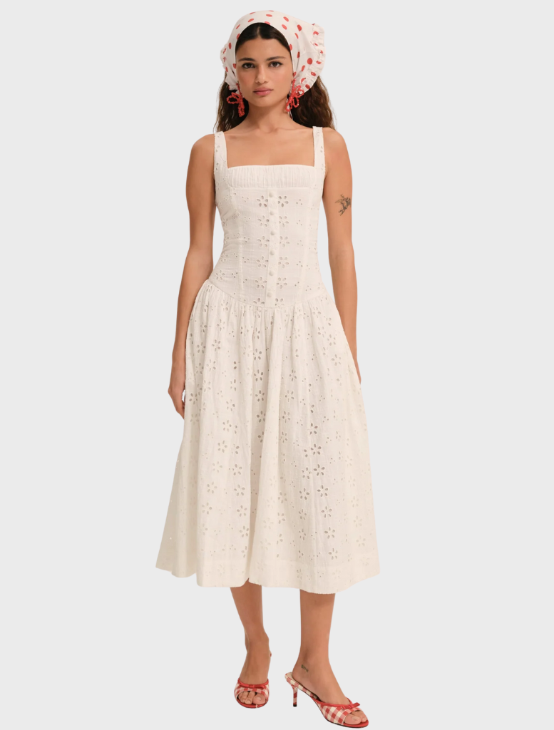 Dreamy white midi dress with a charming daisy design, offering a graceful silhouette and lightweight fabric for comfort.