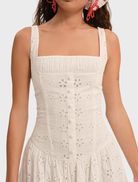 White midi dress featuring a whimsical daisy print, designed with a relaxed fit and gentle draping for a romantic style.