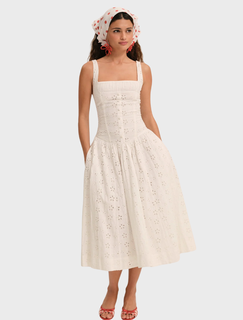 White midi dress with a dreamy daisy print, featuring a flowing silhouette and delicate straps for a feminine look.