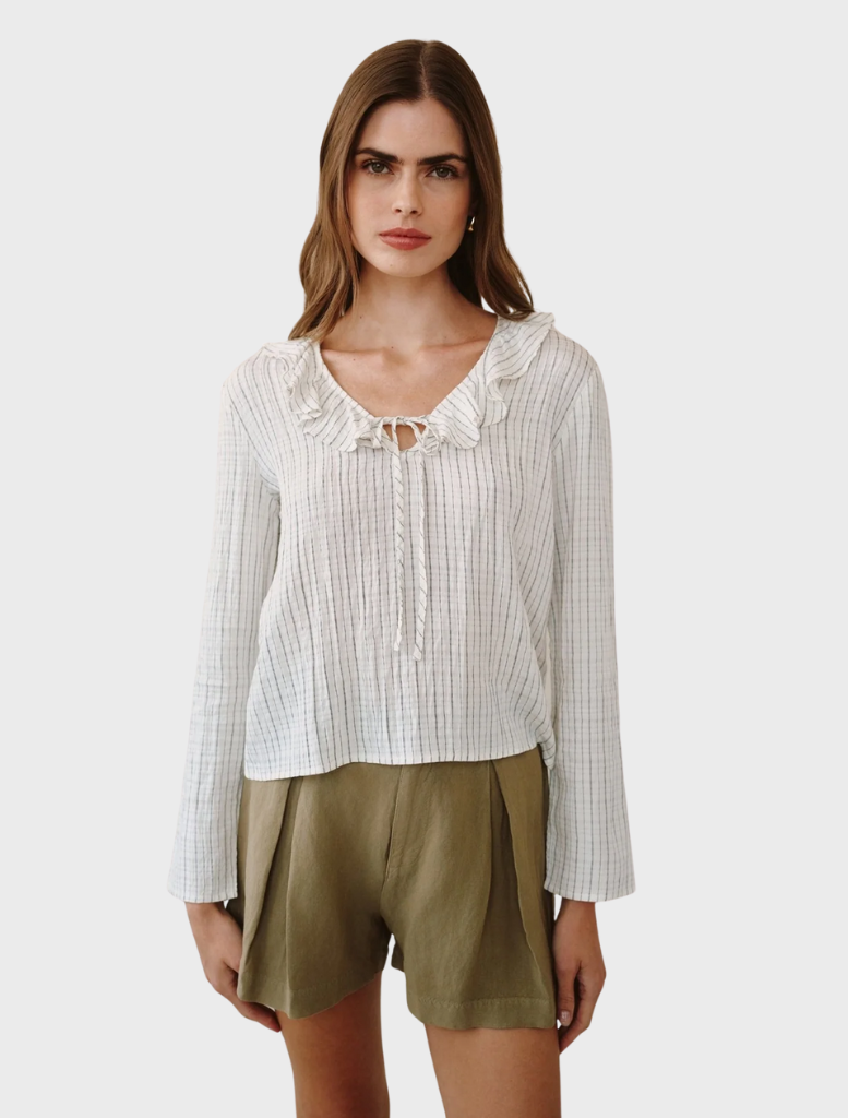 Elegant ecru top with black pinstripes and a ruffle tie neck, perfect for adding sophistication to any outfit.