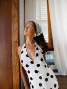 A woman in a brown top models the Elara Necklace, adorned with a large amber stone.