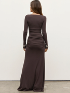 Auri Maxi Dress in a muted smoke shade, characterized by its flowing fabric and sophisticated style for any occasion.