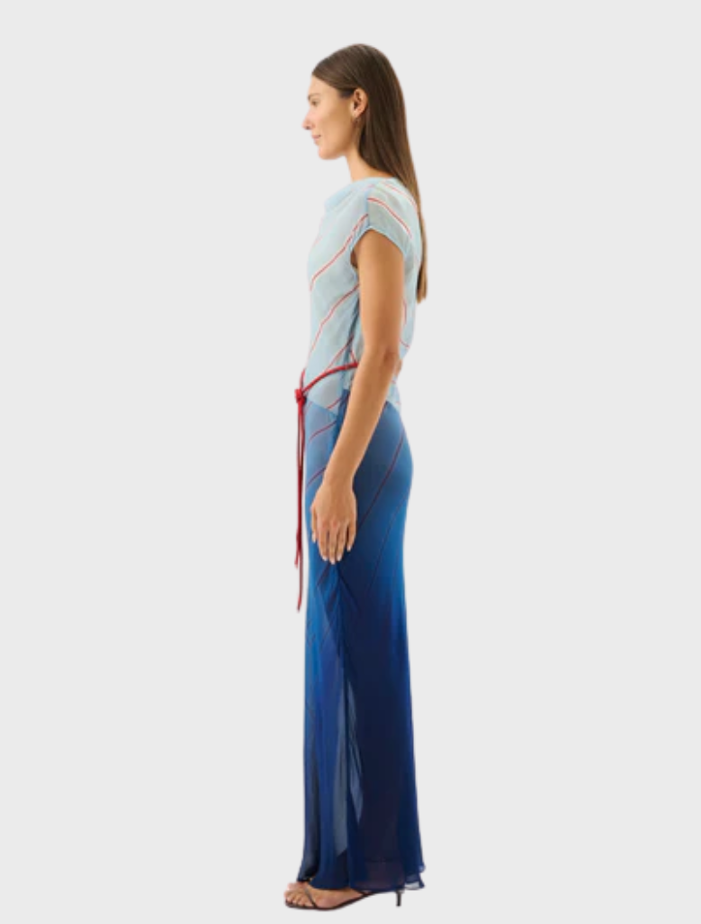 Flowing Capri maxi dress showcasing a bold striped design, inspired by the colors of the ocean.
