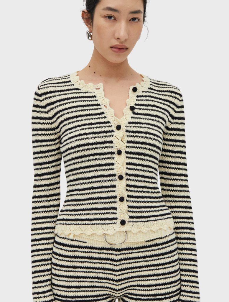 Close-up of a cream and coffee knit cardigan from the Resonance collection, emphasizing its intricate knit pattern and warmth.