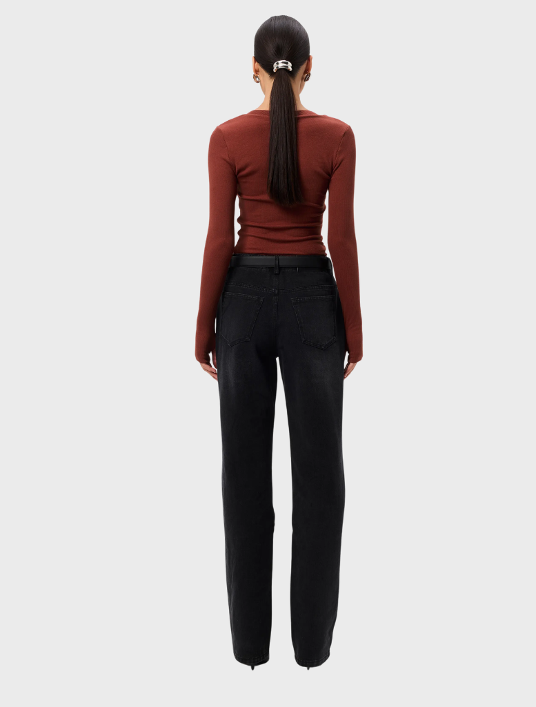 The Sedona Top in rust, featuring a loose silhouette and short sleeves, presented on a model against a neutral background.