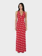 Red polka dot maxi dress with a flowing silhouette, perfect for summer outings or casual gatherings.